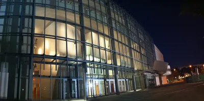 Glass facade of New World Center at night