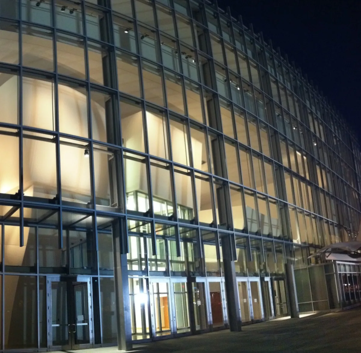 Glass facade of New World Center at night
