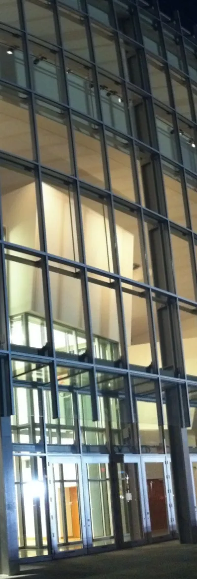 Glass facade of New World Center at night